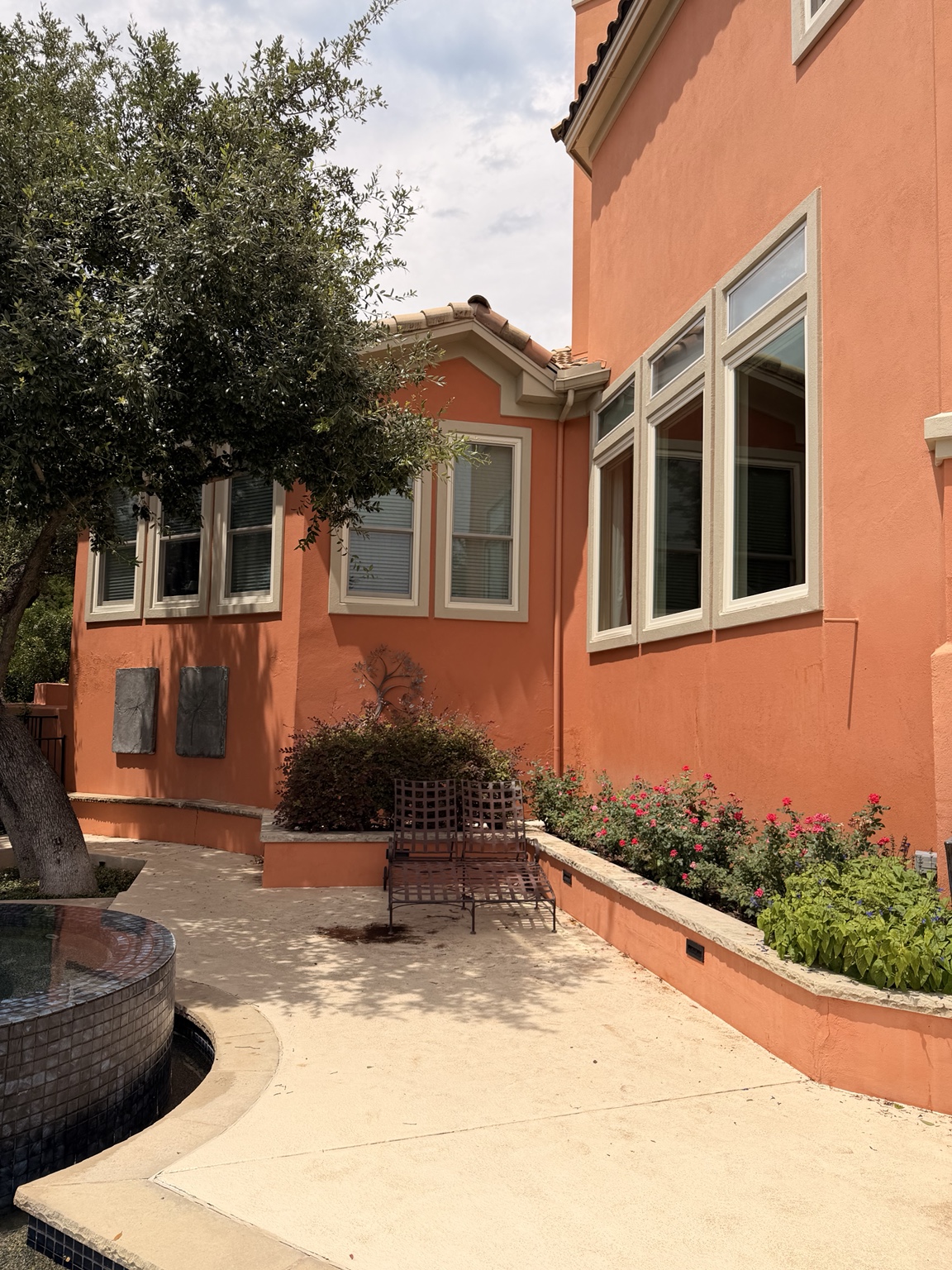 Side elevation of Mediterranean estate with manicured landscaping — Austin, TX