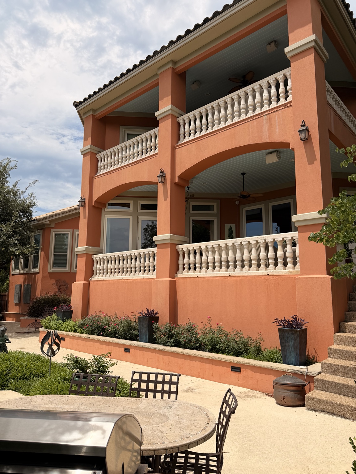 Two-story Mediterranean estate rear elevation with double balcony, cleaned by Precise Panes — Austin, TX